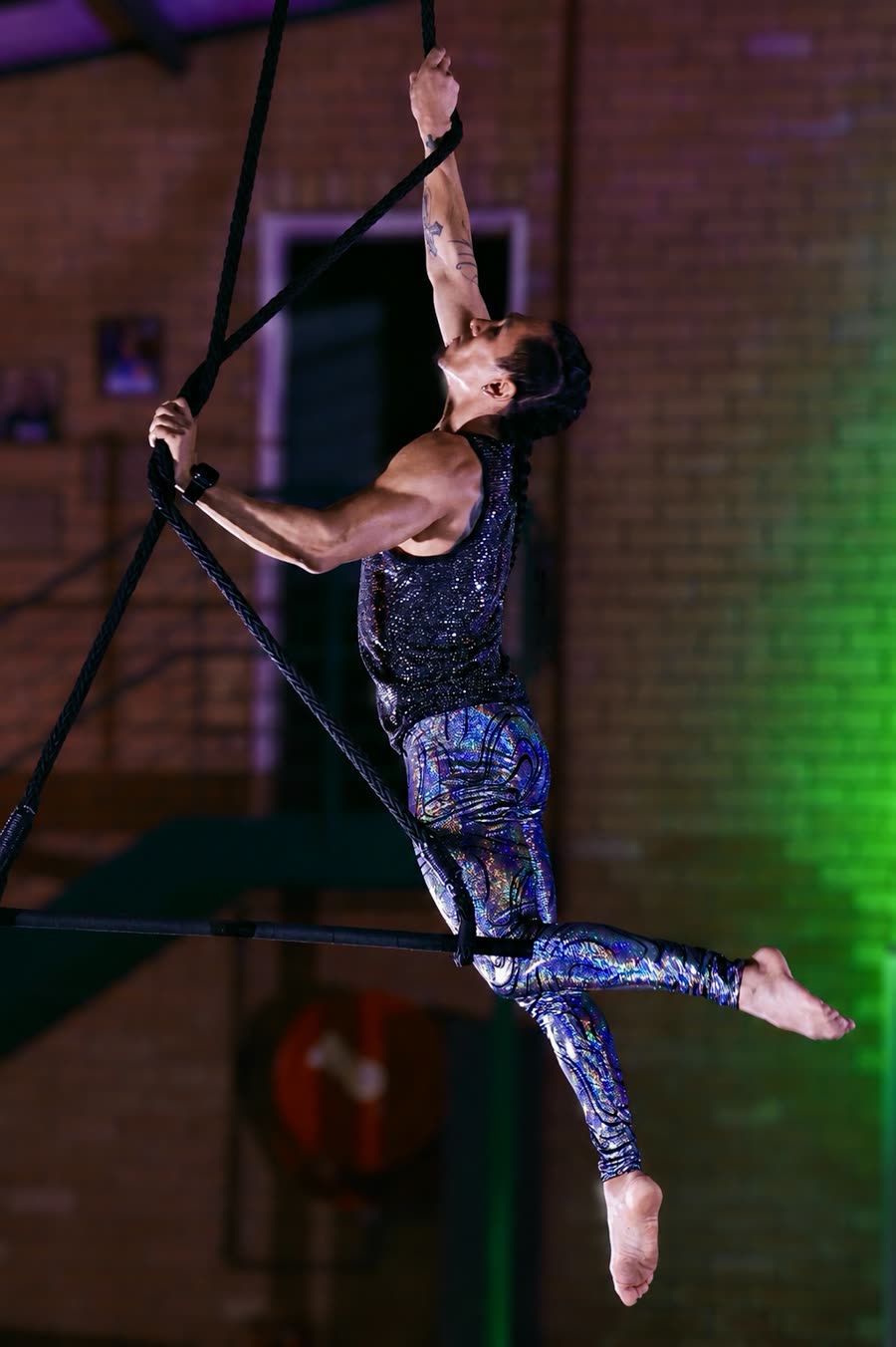 Aerial silks performer suspended mid-drop at a Johannesburg event